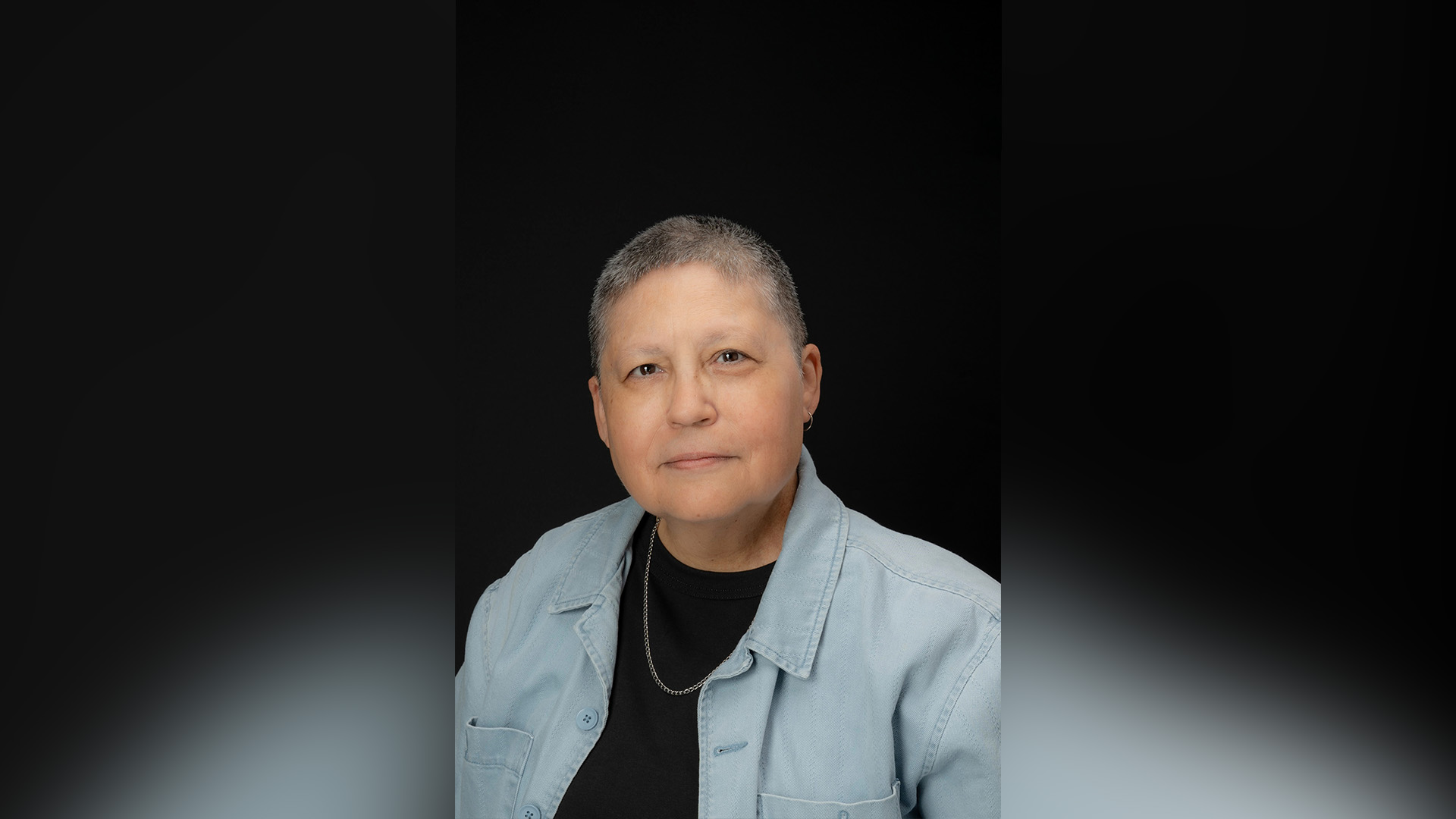 Color Image of woman gently smiling at the camera