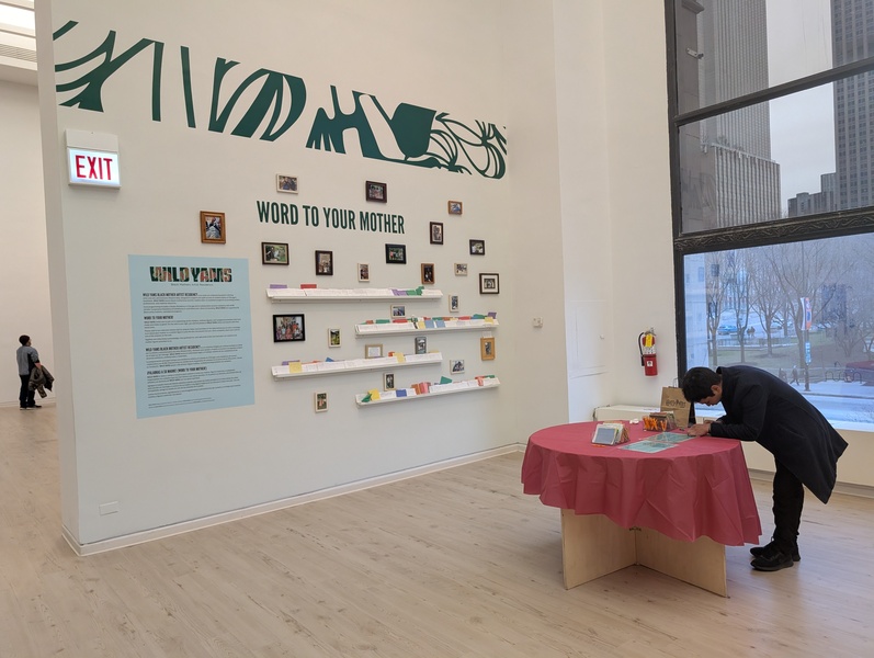  Small objects and post its line the shelves on a wall in a gallery. 