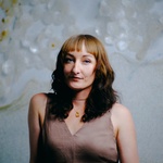 Woman with long brown hair and blue eyes
