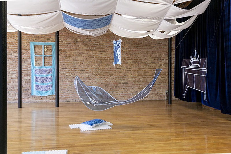  View into a sewn installation that mimics a surreal room blending indoor and outdoor space 