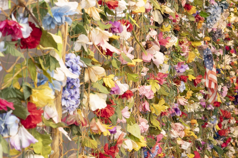  Tapestry of faux and real flowers and various decorations scavenged from garbage bins in cemeteries in Chicago, woven with artificial sinew. 