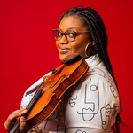 Black woman with glasses, dark braids, and holding a violin on her shoulder