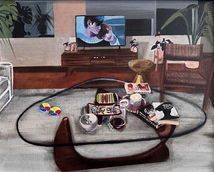  A glass Isamu Noguchi coffee table with a wine glass and pile of books is in the foreground and a TV playing a Boy Love drama featuring a couple cuddling is in the background. 
