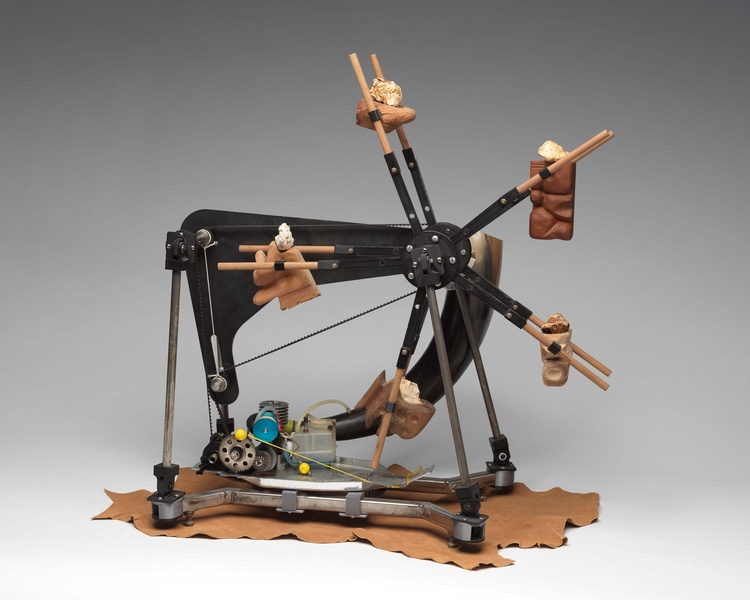  A sculpture of a machine that mirrors a swing machine with a propellor attached. 