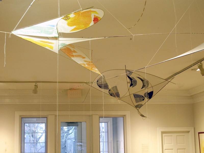  An installation of abstract kites on the ceiling of a gallery. 