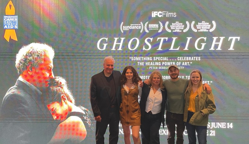  five people standing in front of a film marquee for the film Ghostlight 