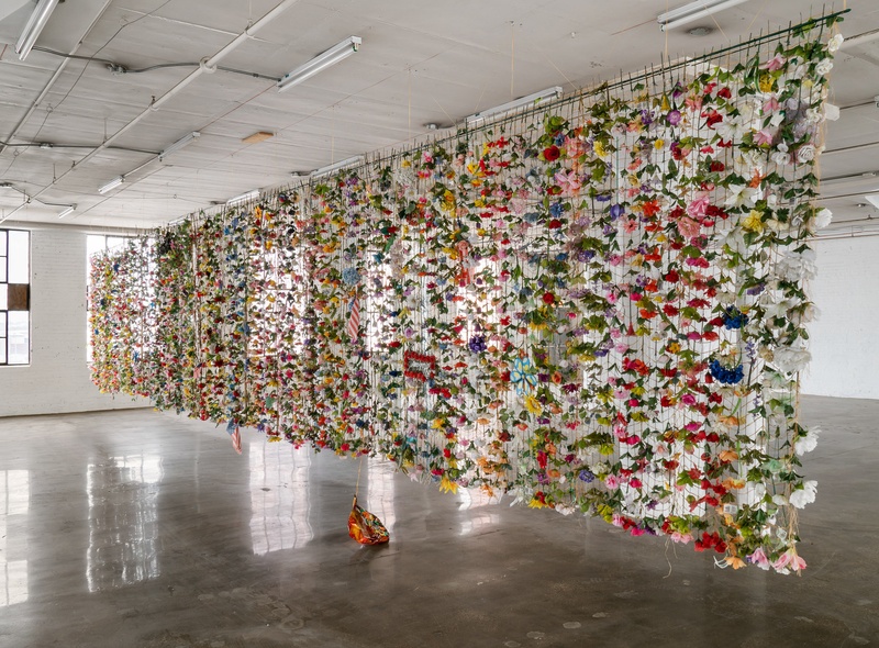  Tapestry of faux and real flowers and various decorations scavenged from garbage bins in cemeteries in Chicago, woven with artificial sinew. 
