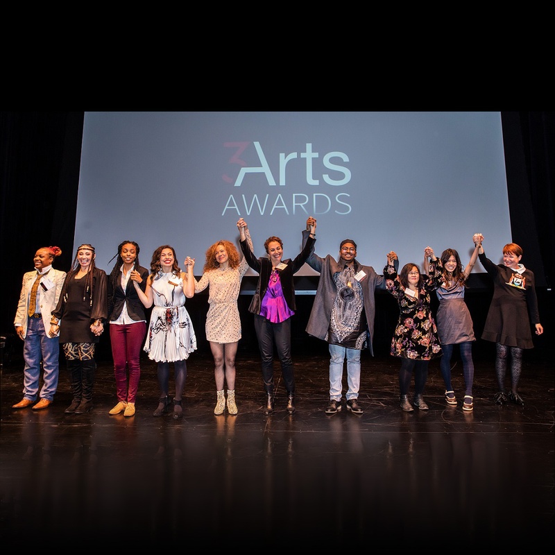 The 2018 3Arts Awardees holding hands on stage at the Museum of Contemporary Art
