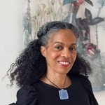 Black/African American Woman with Wavy colored hair and Brown eyes