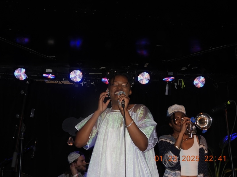  A Black/African-American Woman sings on stage. 