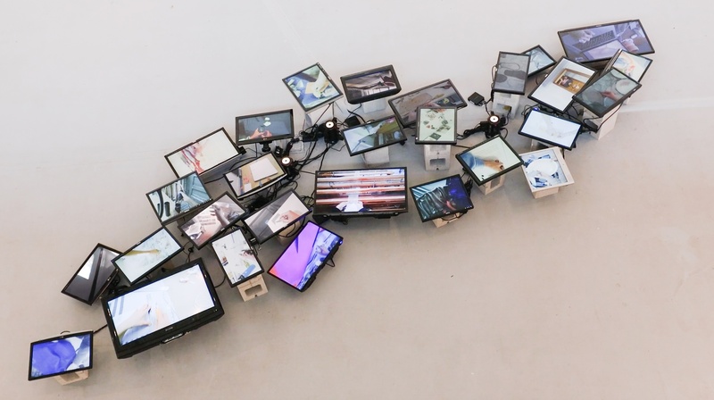  small monitors laid on the gallery floor each one depicting a different image. 