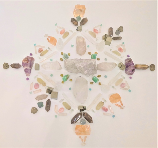  a geometric arrangement of different sized and colored crystals 