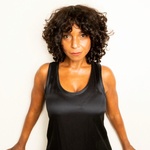 Actor in navy blue sleeveless dress