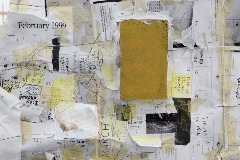  Detail view of a collage of black and white papers sewn onto a tshirt. Composed of photocopied calendar paper with different appointments written on the days, with some areas highlighted in yellow. 