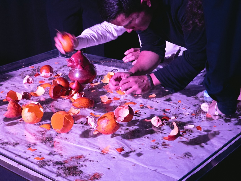  A performer smashes egg shells on a towel. 