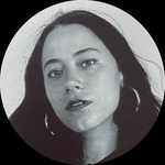 A black and white photo of a Colombian woman with long dark hair.