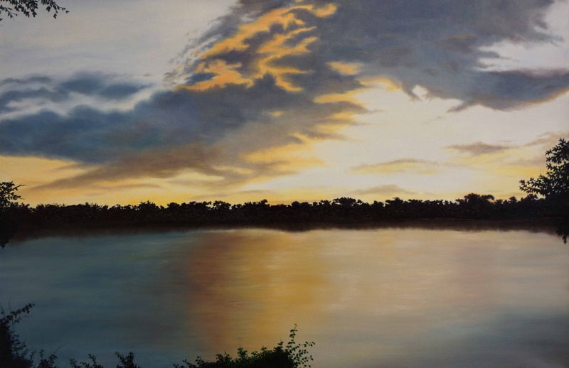  Landscape painting of a serene sunset or sunrise with calm lake in foreground and distant horizon of trees against a streak of blue and amber clouds 