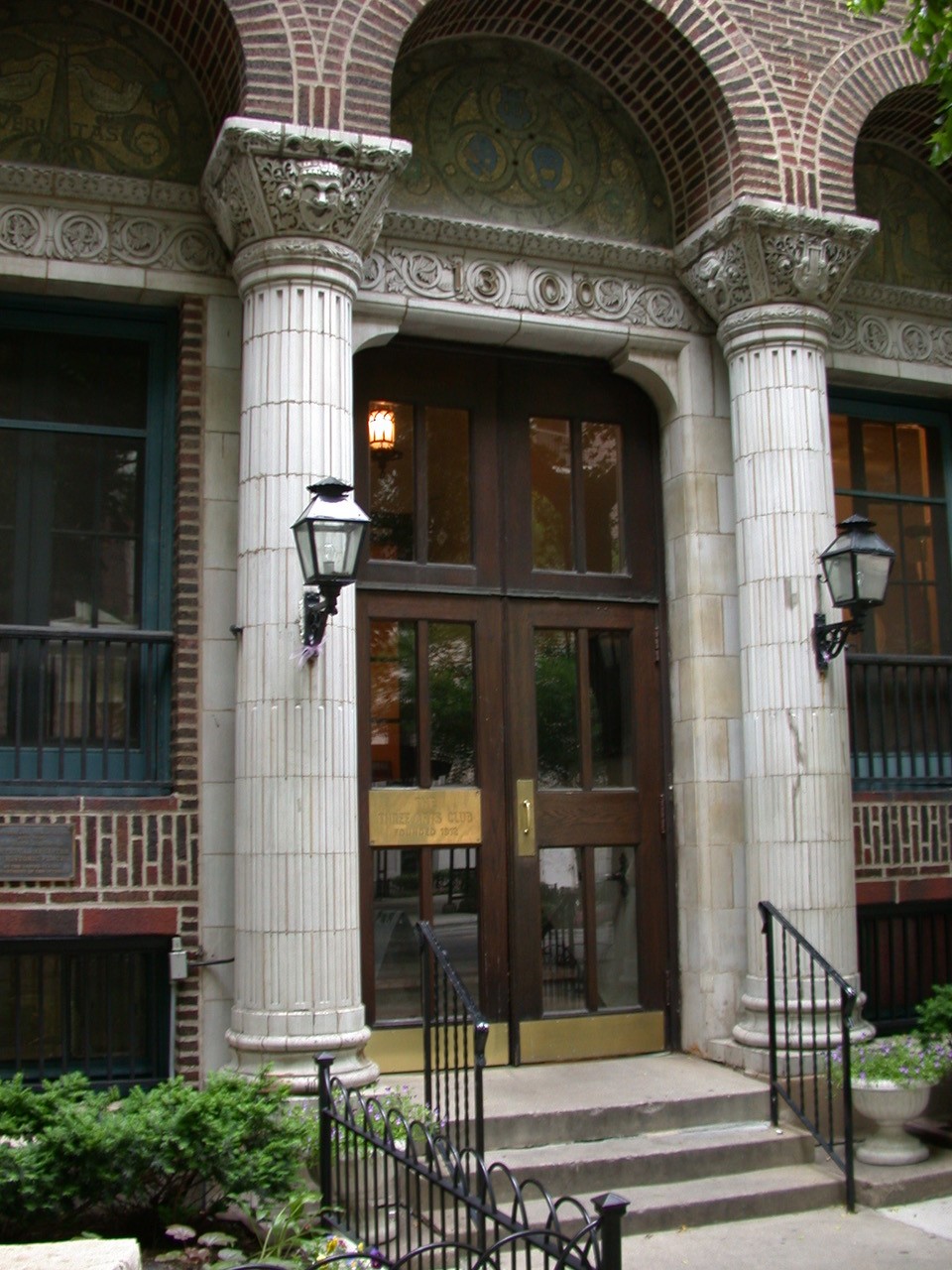 Image of wooden double doors flanked by decorative columns serving as the entrance to the Three Arts Club building
