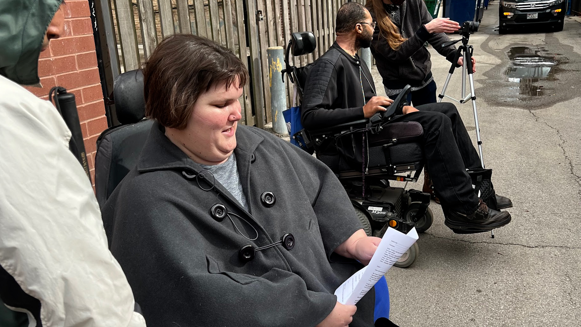 Kennedy Healy in a Chicago alley directing a camera person