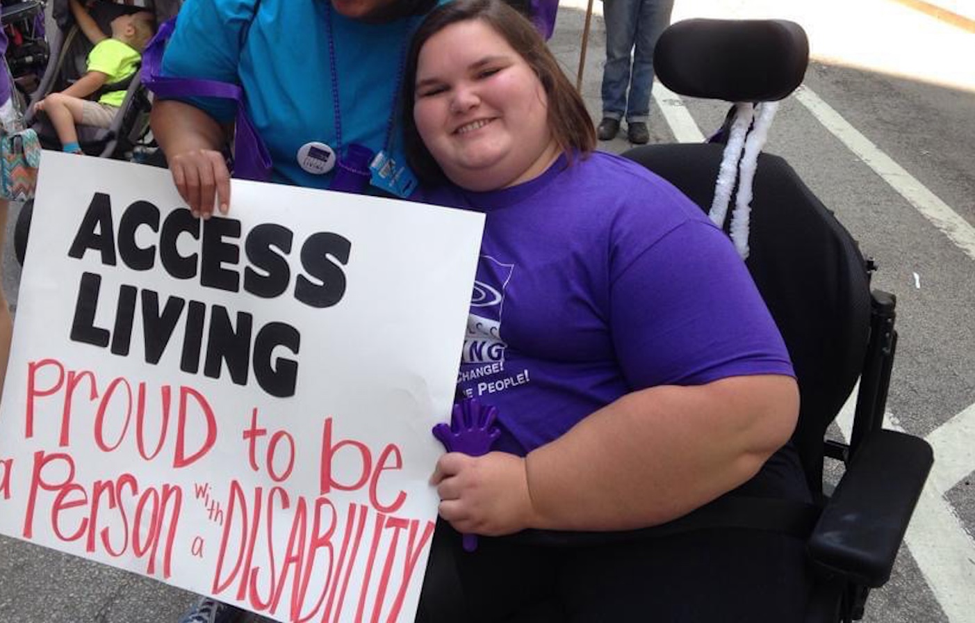 Kennedy at a parade holding a sign